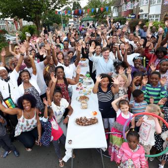 People waving at a street party